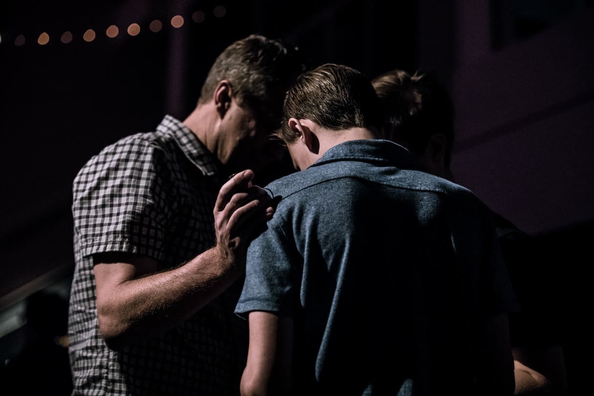 three people huddled together